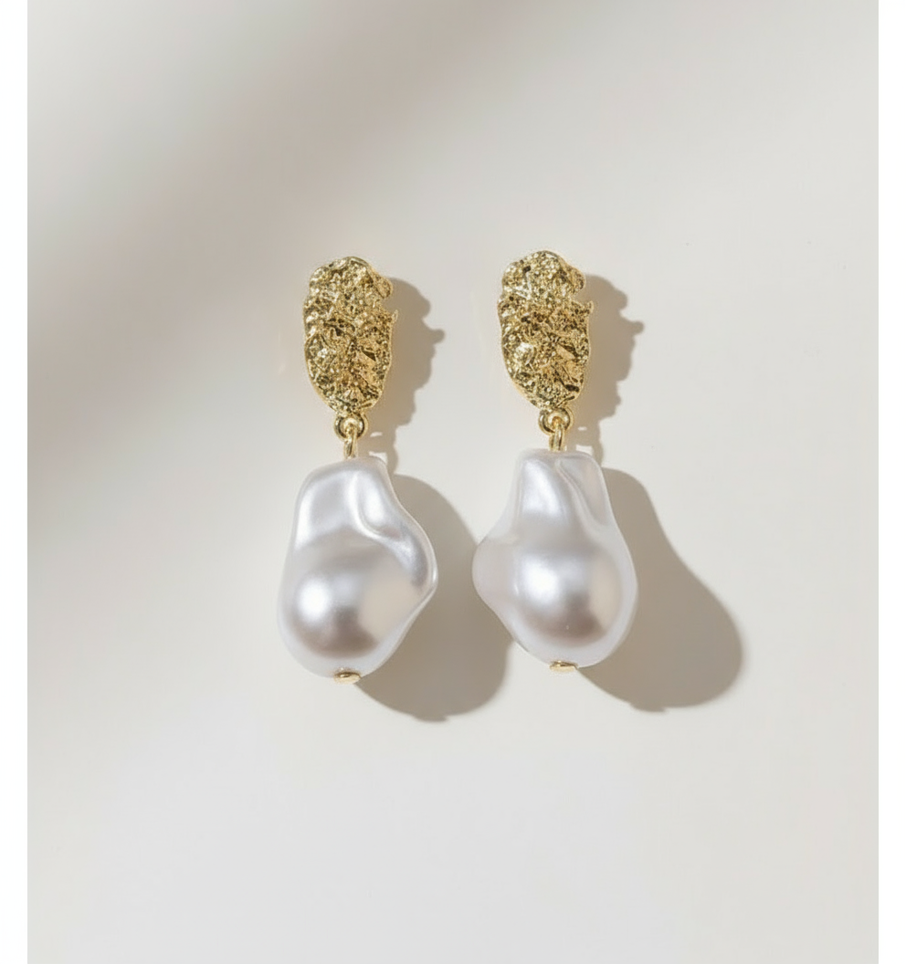 Even white backdrop with overhead lighting for pearl earrings