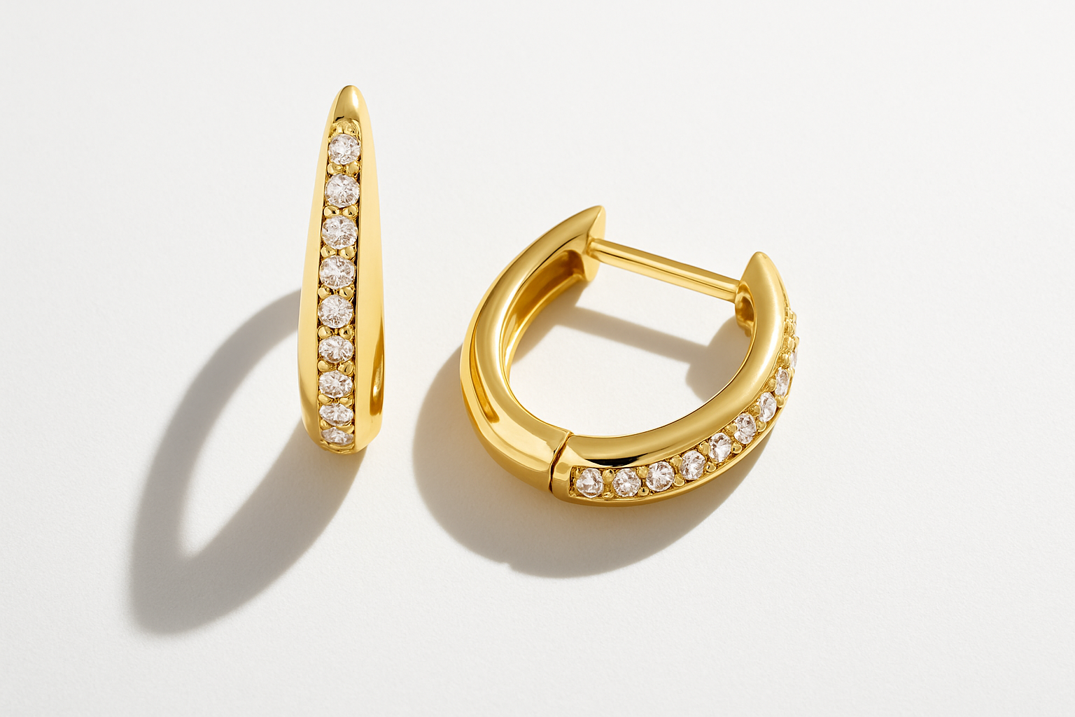 Flatlay image of Diamanté Portofino Huggies gold with white backdrop and flash shadows