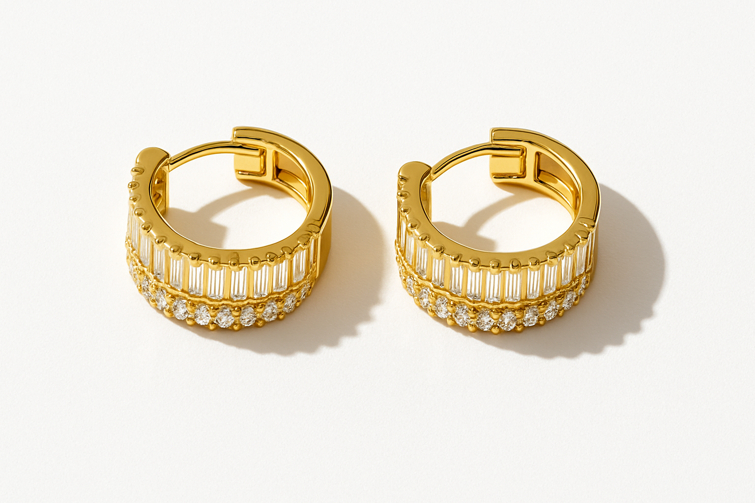 Gold crystal huggie earrings studio flatlay