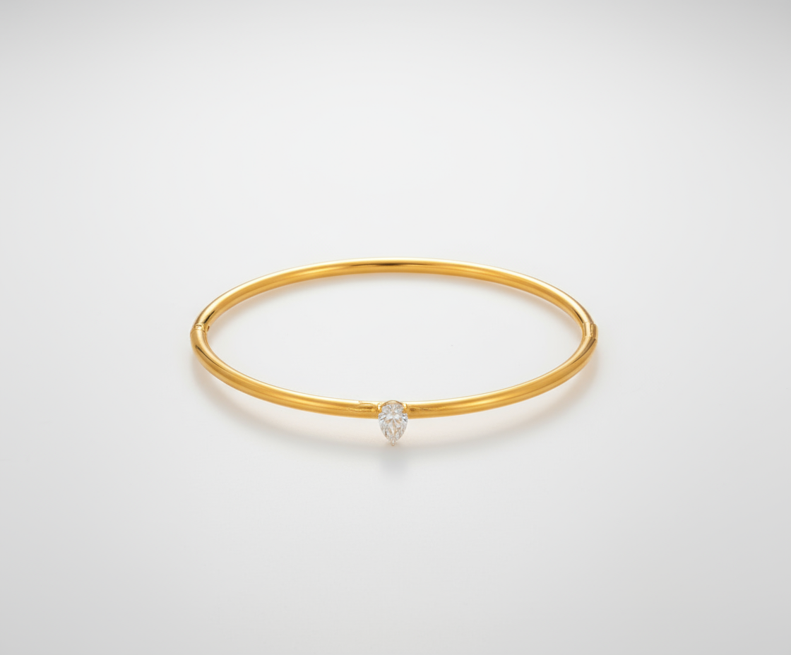 Professional studio backdrop for gold bangle with crystal charm