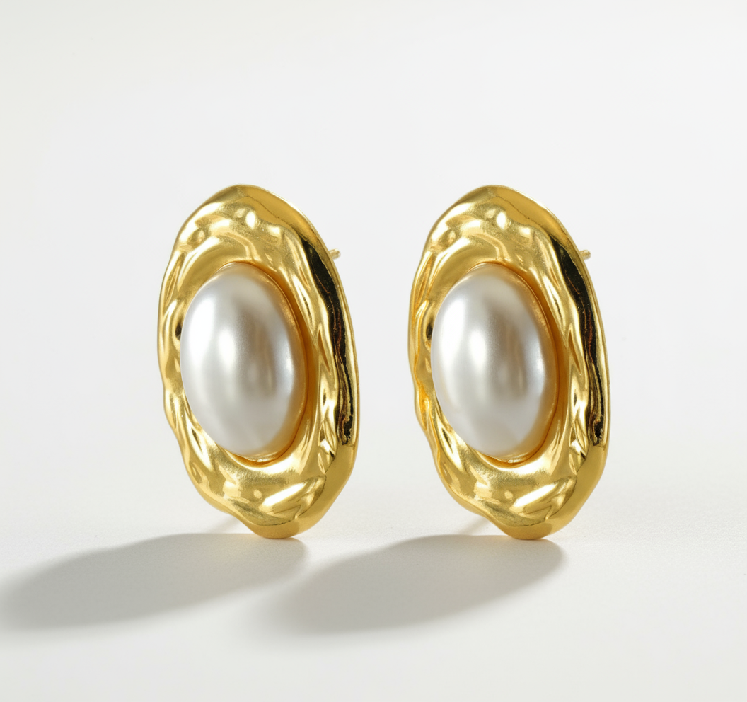 Professional studio backdrop for gold pearl earrings with sculptural frame