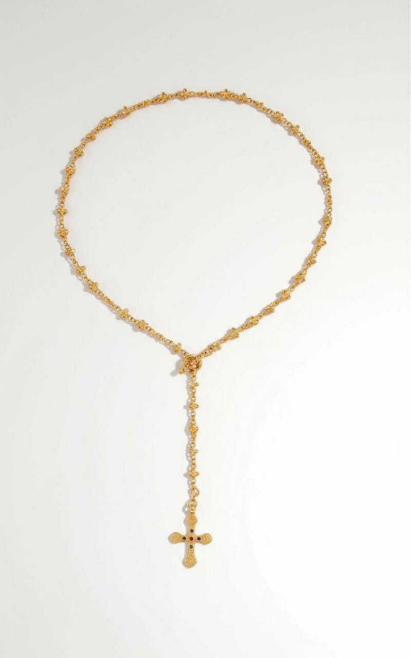 Professional studio backdrop for gold rosary necklace with cross