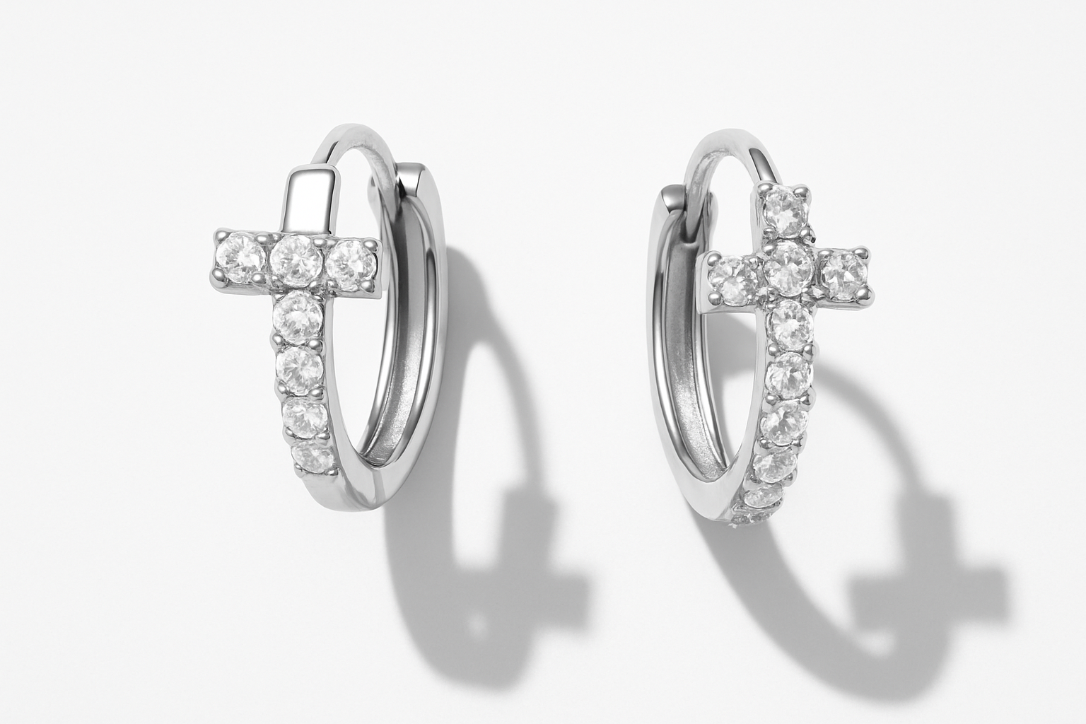 Professional studio flatlay of T-shaped crystal huggie earrings in silver