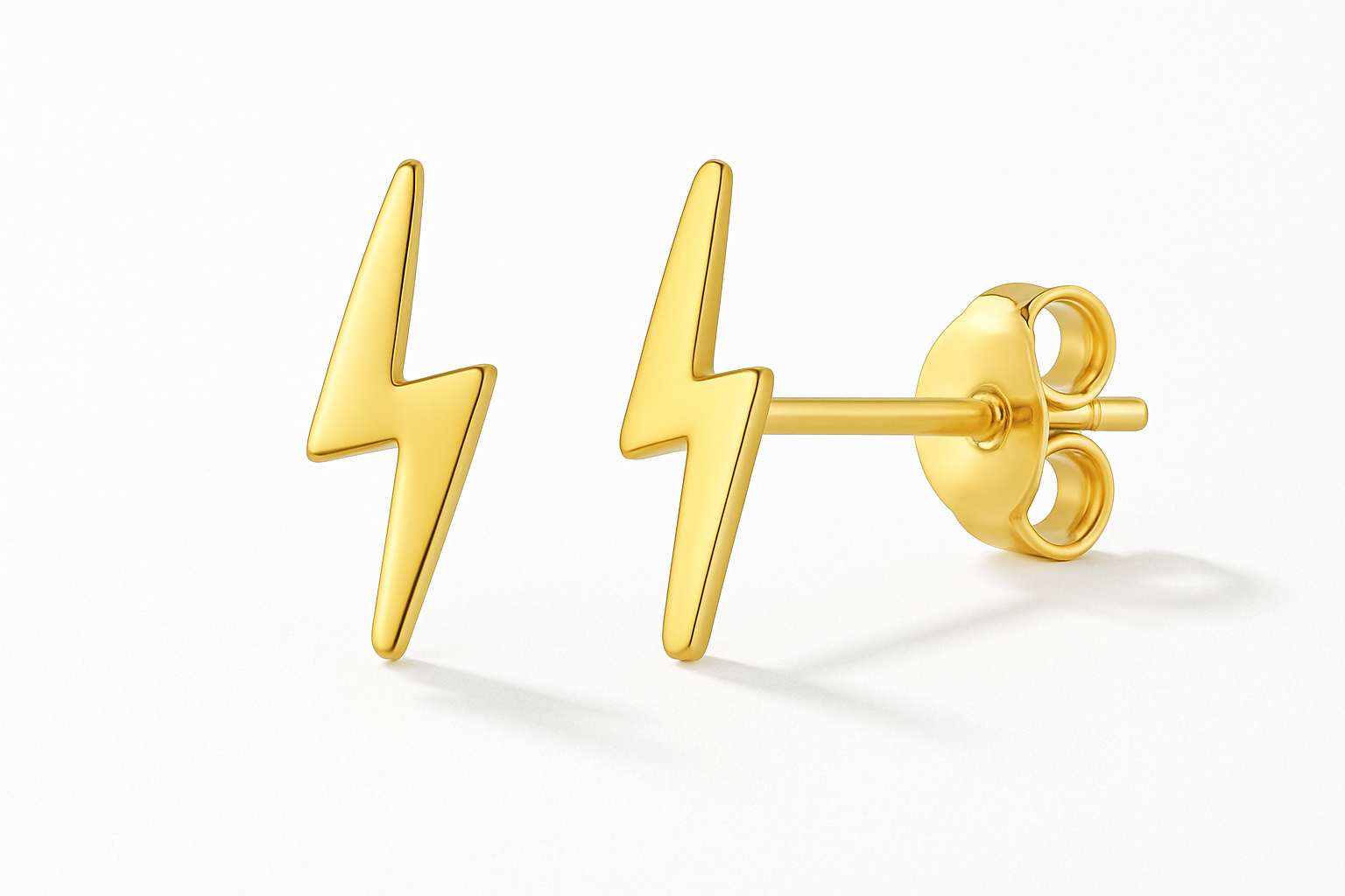 Professional studio photograph of gold lightning bolt stud earrings